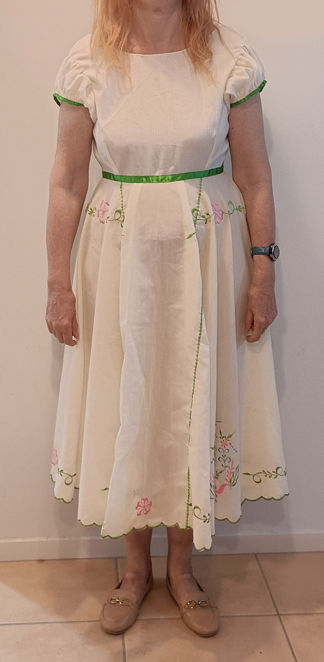 A white summer dress with green details and a full skirt made out of embroidered vintage fabric by Velvet Cherry, Wellington, New Zealand.